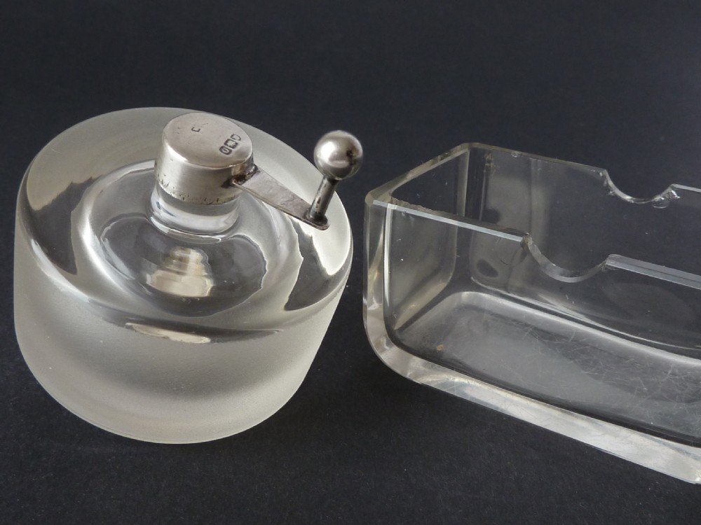 A Victorian clear glass stamp moistener featuring a thick frosted glass wheel mounted on hallmarked sterling silver fittings. View VI