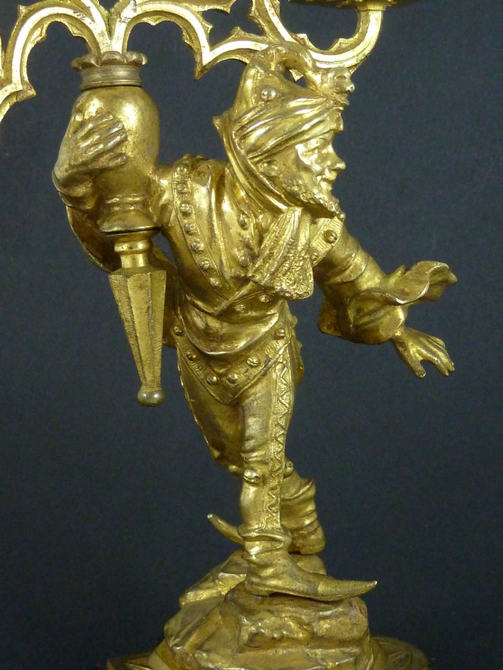 A pair of gilt bronze twin-light figural candelabra featuring sculpted Renaissance figures supporting branching candle arms set upon dark marble bases. View VII