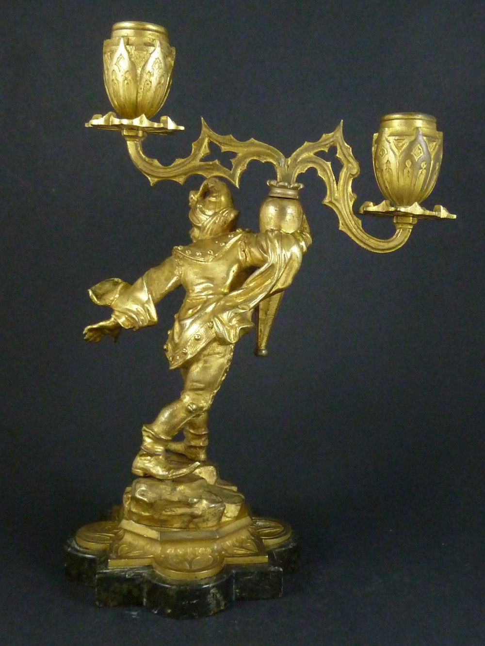A pair of gilt bronze twin-light figural candelabra featuring sculpted Renaissance figures supporting branching candle arms set upon dark marble bases. View VIII
