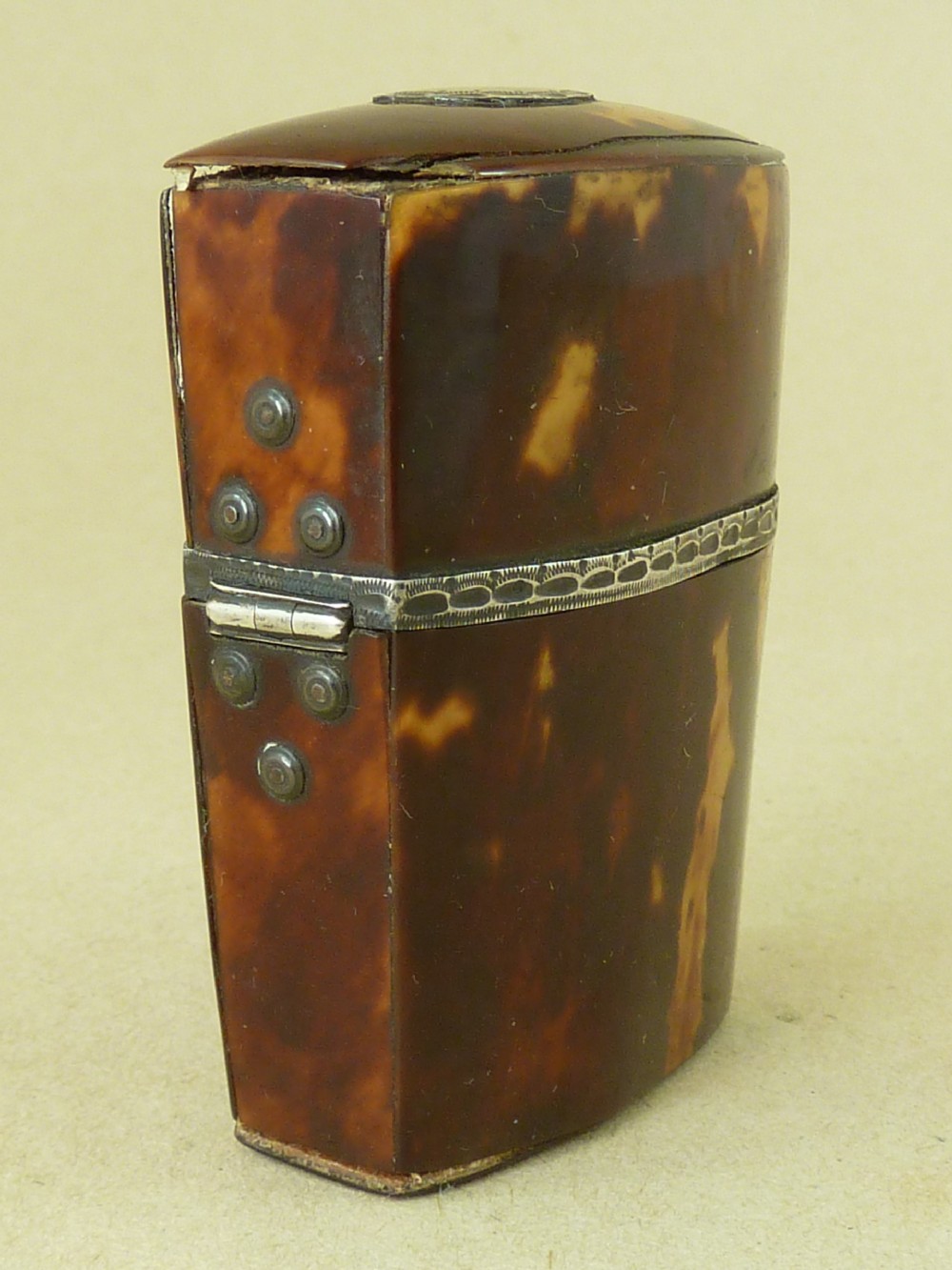 An opened Georgian tortoiseshell etui case lined with red velvet, containing a small clear glass perfume bottle with a faceted stopper. View V