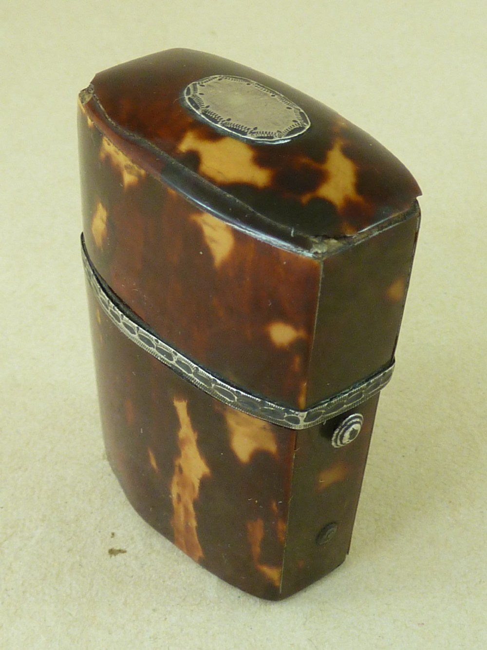 An opened Georgian tortoiseshell etui case lined with red velvet, containing a small clear glass perfume bottle with a faceted stopper. View VI