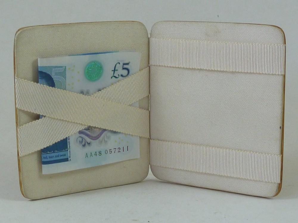 A closed two-panel Art Deco magic wallet with a mottled amber brown tortoiseshell exterior and rounded edges. View IV