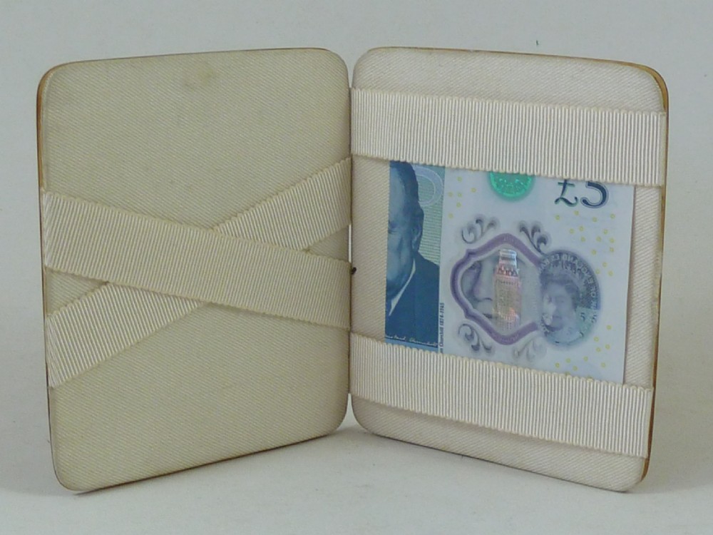 A closed two-panel Art Deco magic wallet with a mottled amber brown tortoiseshell exterior and rounded edges. View V