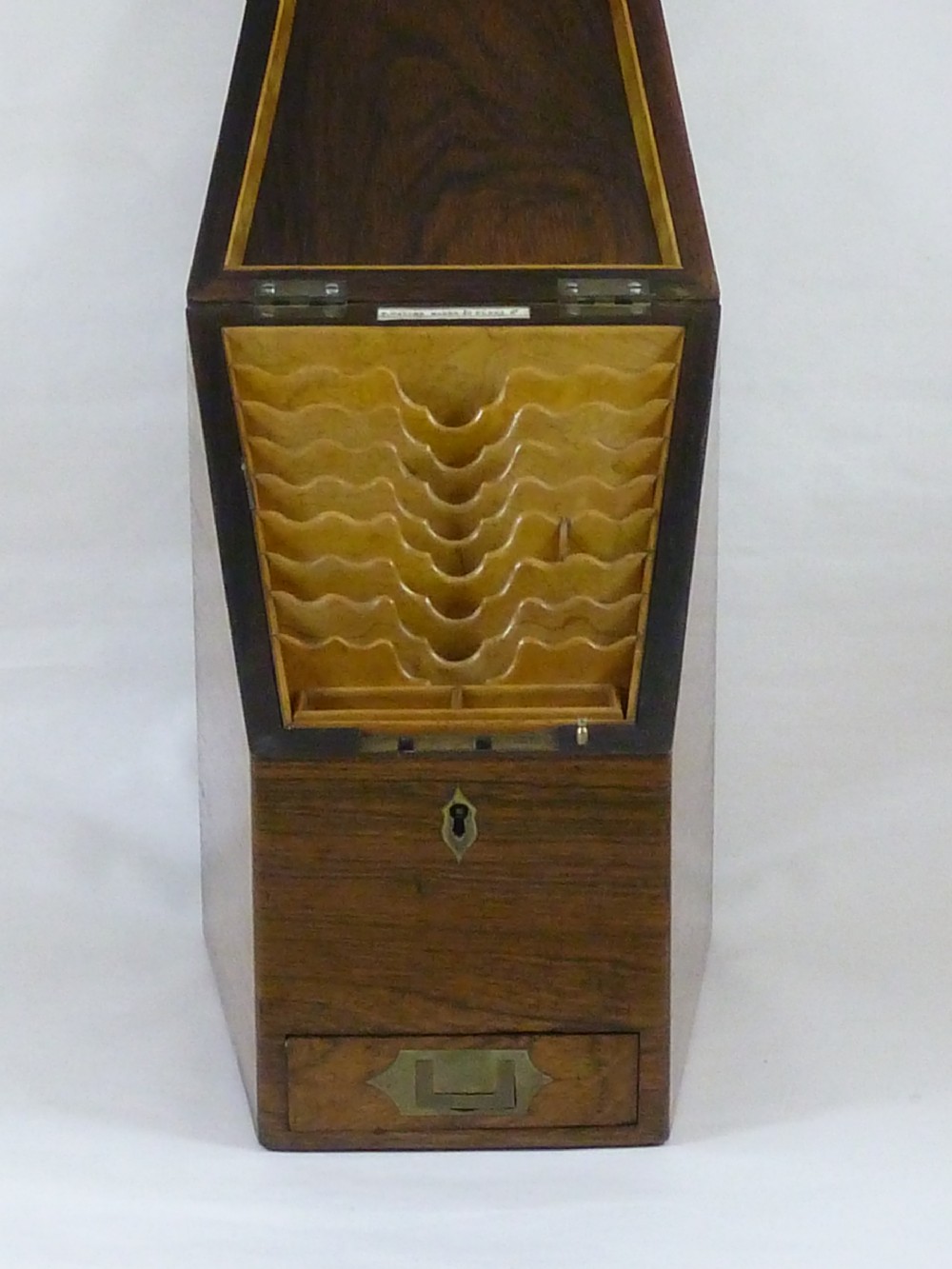 A Victorian rosewood sloping desktop stationery cabinet with open hinged lid revealing tiered light-wood compartments and a lower drawer with brass handle. View III