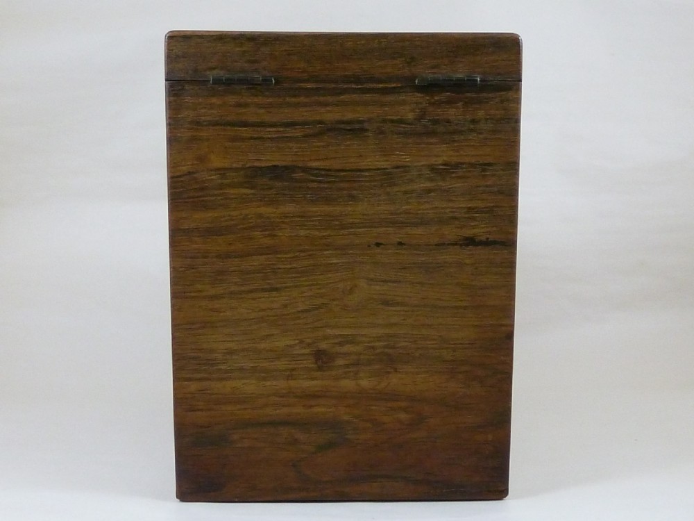 A Victorian rosewood sloping desktop stationery cabinet with open hinged lid revealing tiered light-wood compartments and a lower drawer with brass handle. View VII