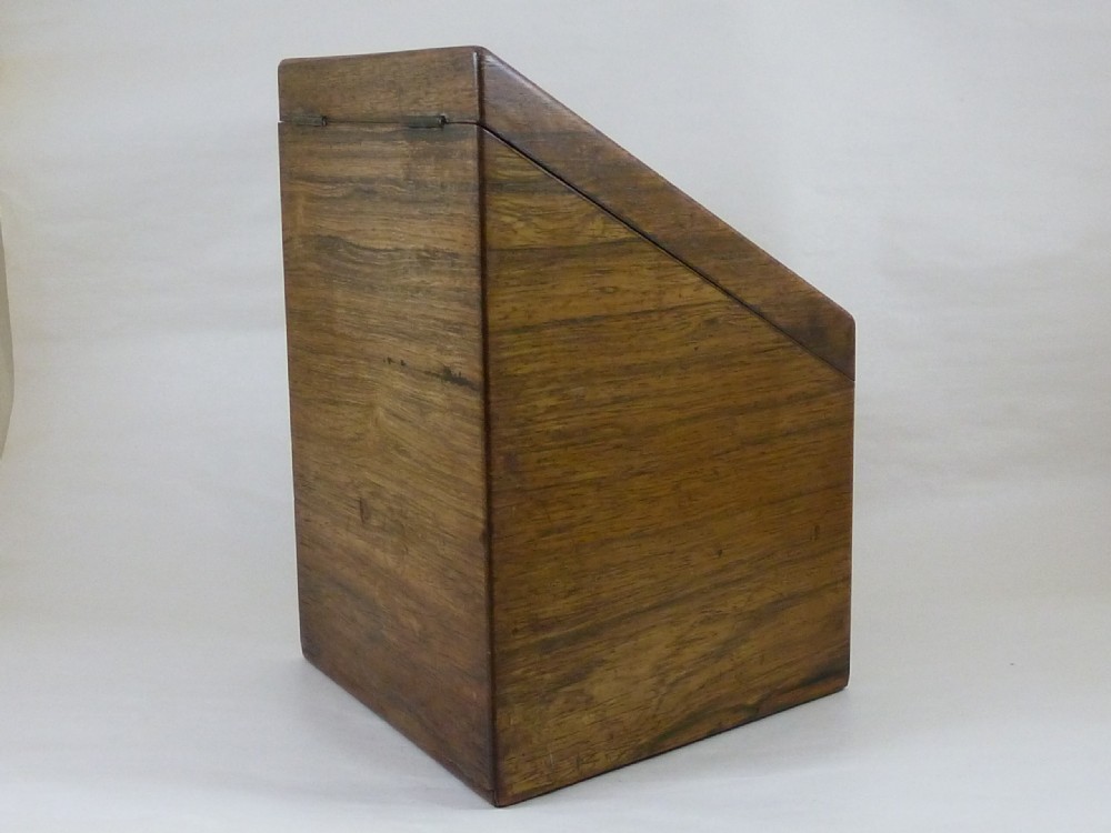 A Victorian rosewood sloping desktop stationery cabinet with open hinged lid revealing tiered light-wood compartments and a lower drawer with brass handle. View IX