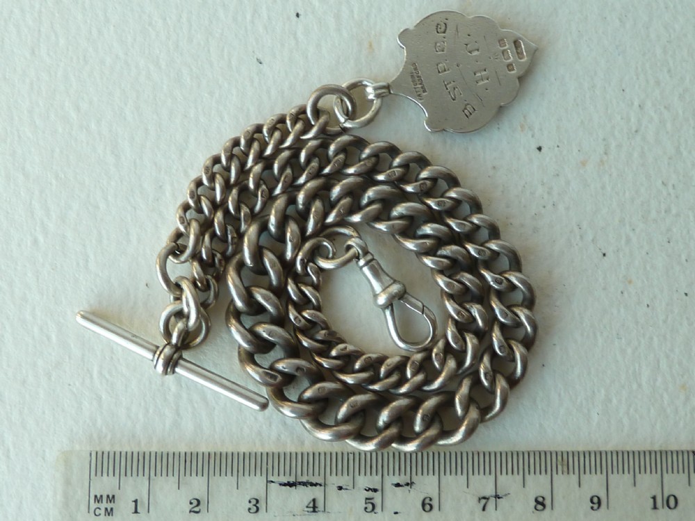 A solid sterling silver Victorian Albert pocket watch chain featuring curb links, a T-bar, swivel clasp, and a heraldic enamelled shield fob. View III