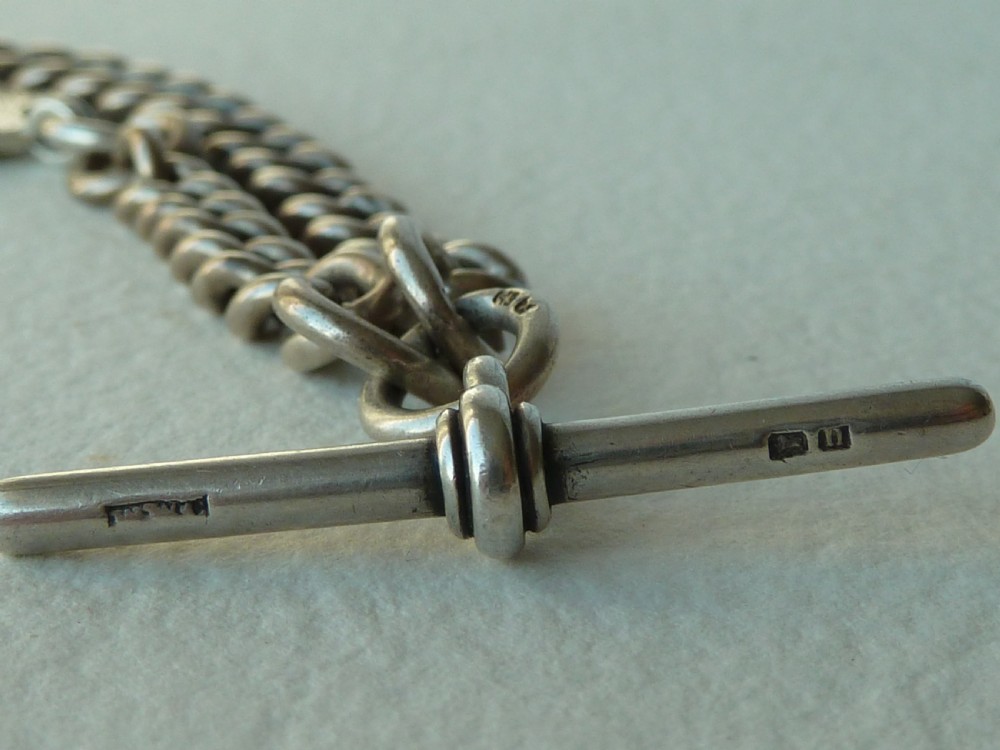 A solid sterling silver Victorian Albert pocket watch chain featuring curb links, a T-bar, swivel clasp, and a heraldic enamelled shield fob. View VII