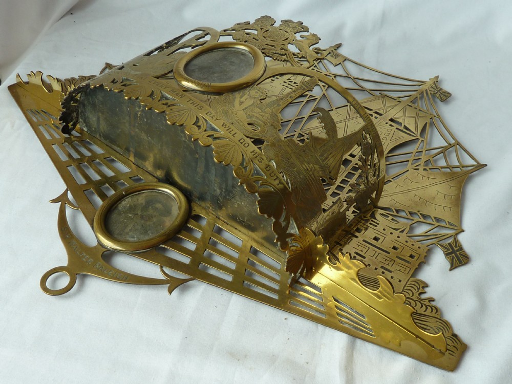 An ornate Victorian pressed brass wall pocket featuring a detailed nautical scene with sailing ships, crests, and portrait medallions. View VII