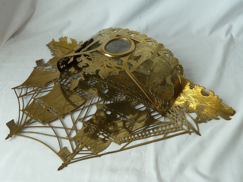 An ornate Victorian pressed brass wall pocket featuring a detailed nautical scene with sailing ships, crests, and portrait medallions. View VIII