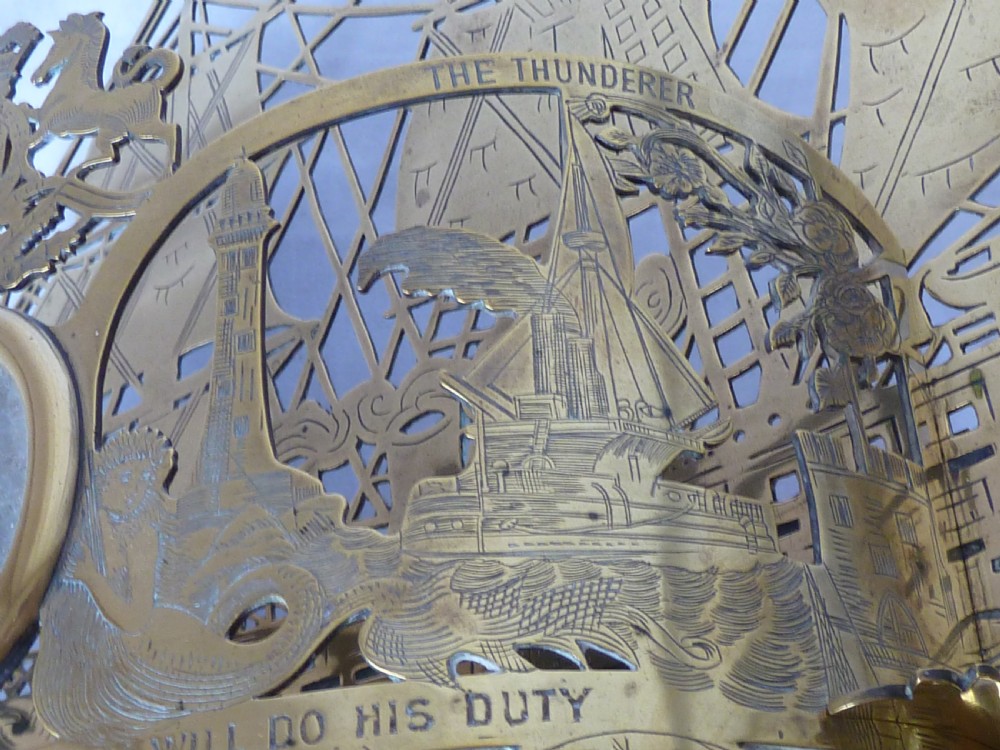 An ornate Victorian pressed brass wall pocket featuring a detailed nautical scene with sailing ships, crests, and portrait medallions. View XIII