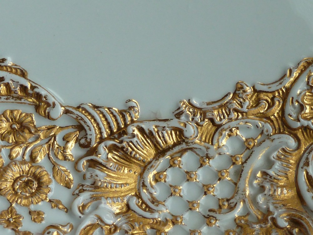 A circular white Meissen porcelain dish featuring a hand-painted illustration of two birds on branches, surrounded by a heavily gilded and pierced Rococo rim. View VII