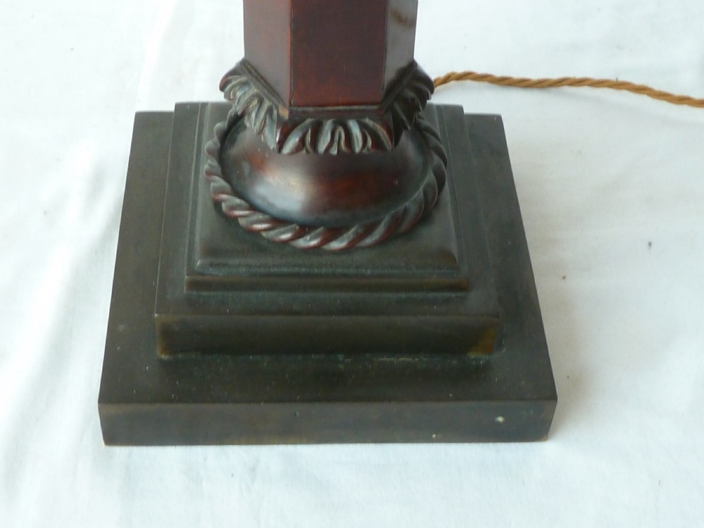 A tall mahogany column table lamp featuring a cast bronze eagle perched at the top above a stepped square plinth base. View III