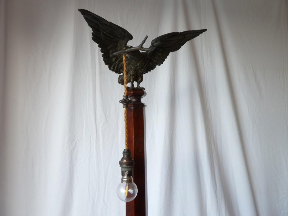 A tall mahogany column table lamp featuring a cast bronze eagle perched at the top above a stepped square plinth base. View IV