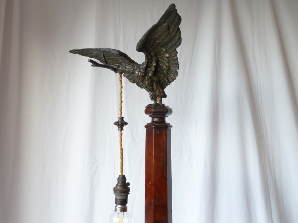 A tall mahogany column table lamp featuring a cast bronze eagle perched at the top above a stepped square plinth base. View VII