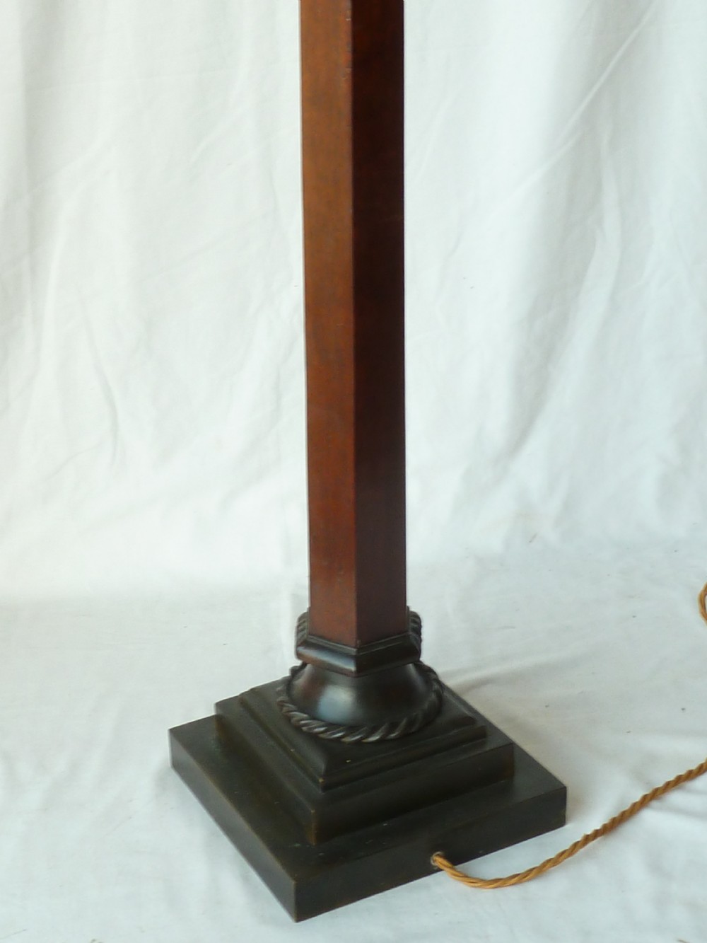 A tall mahogany column table lamp featuring a cast bronze eagle perched at the top above a stepped square plinth base. View IX