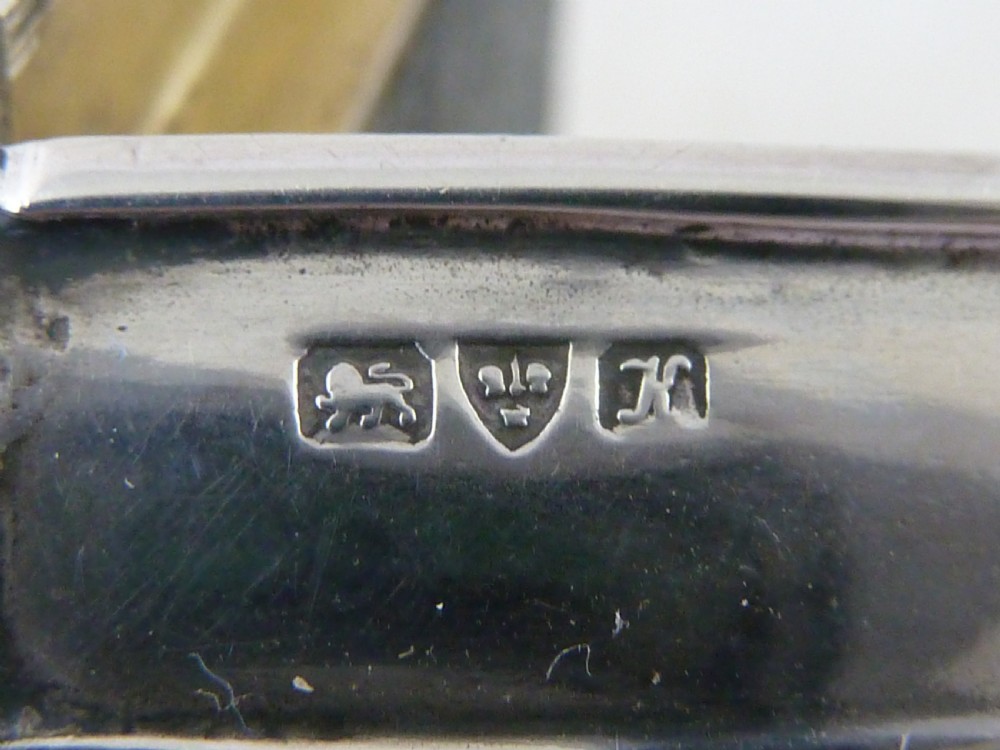 An Edwardian sterling silver double stamp case shaped like a garden trug with an overhead handle and two glazed stamp display compartments. View VIII