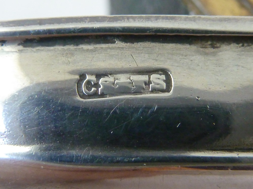 An Edwardian sterling silver double stamp case shaped like a garden trug with an overhead handle and two glazed stamp display compartments. View IX