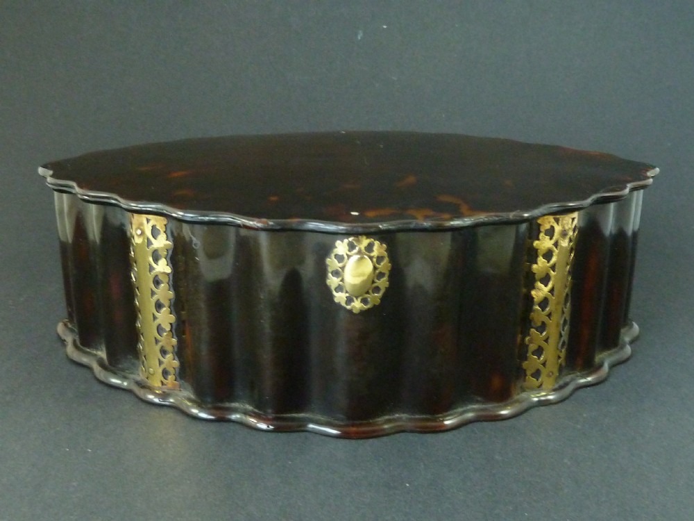 An eighteenth-century lobed Dutch Colonial tortoiseshell casket featuring pierced silver-gilt strapwork mounts and an oval lock plate. View II