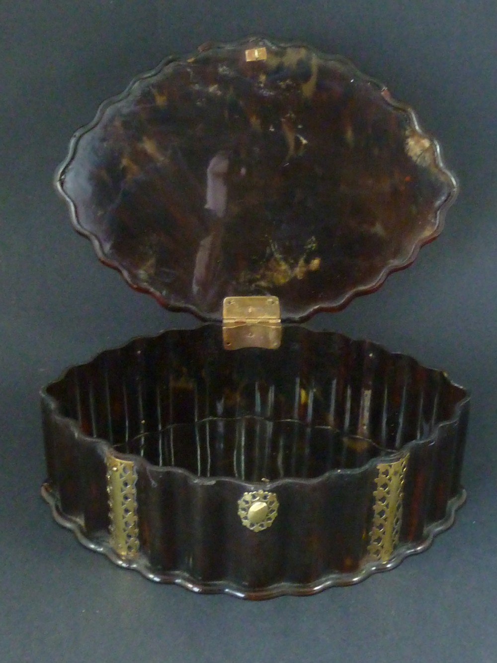 An eighteenth-century lobed Dutch Colonial tortoiseshell casket featuring pierced silver-gilt strapwork mounts and an oval lock plate. View VI