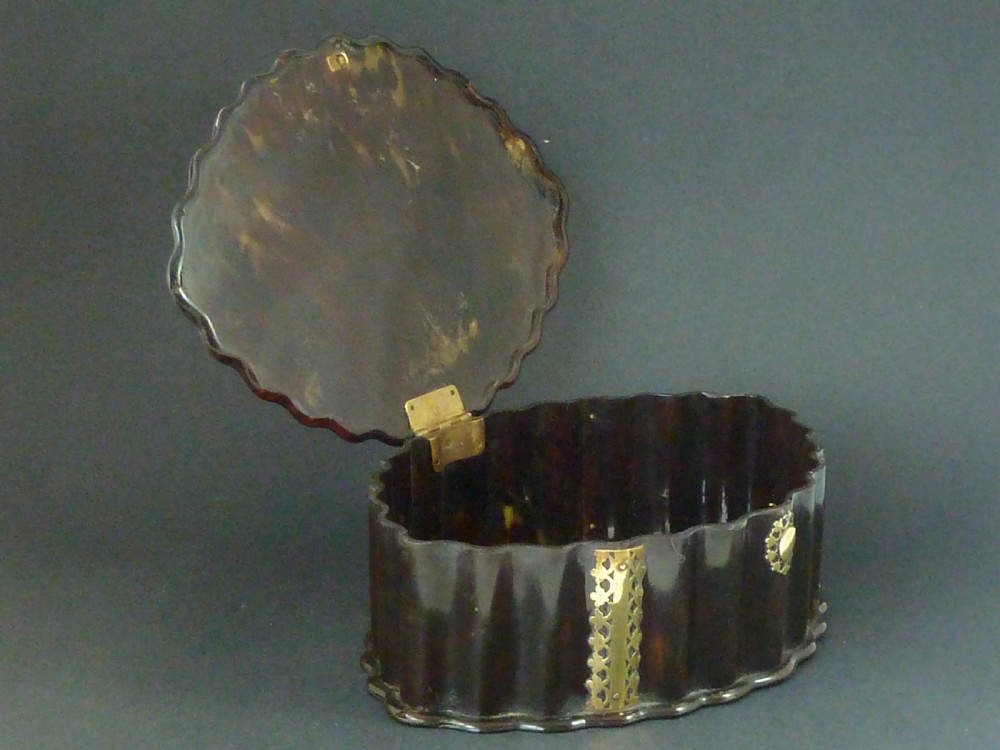 An eighteenth-century lobed Dutch Colonial tortoiseshell casket featuring pierced silver-gilt strapwork mounts and an oval lock plate. View VII