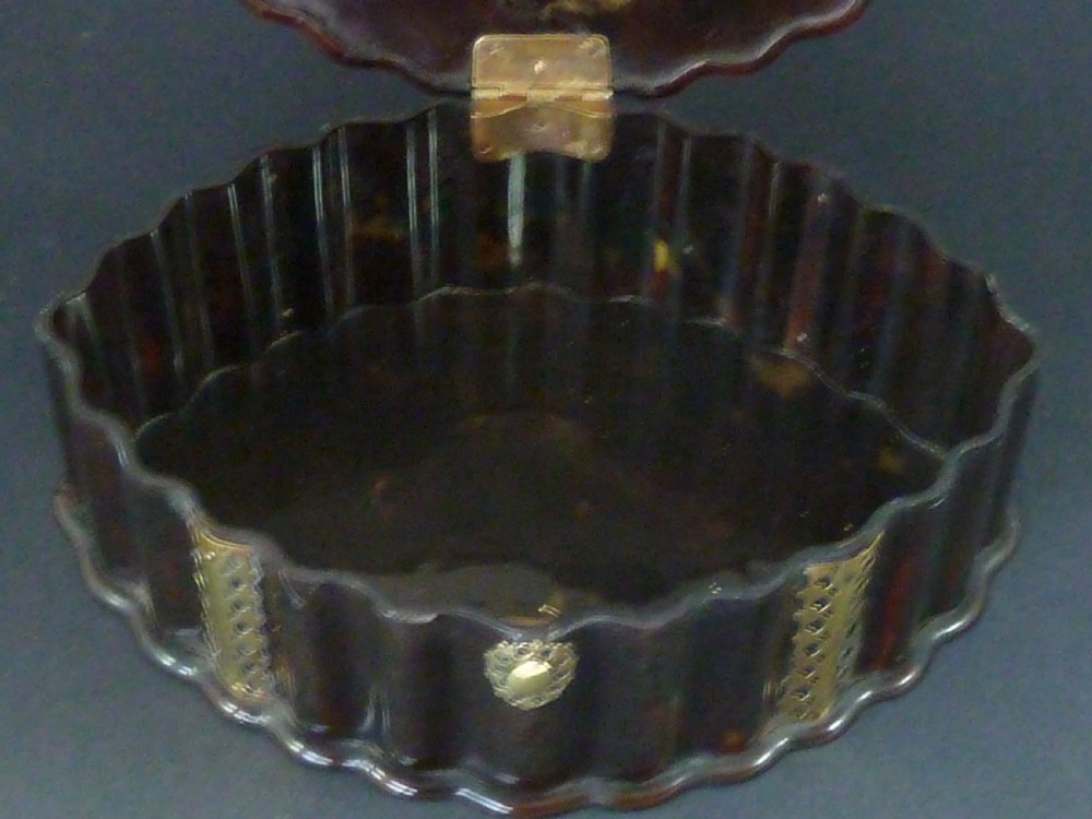 An eighteenth-century lobed Dutch Colonial tortoiseshell casket featuring pierced silver-gilt strapwork mounts and an oval lock plate. View VIII