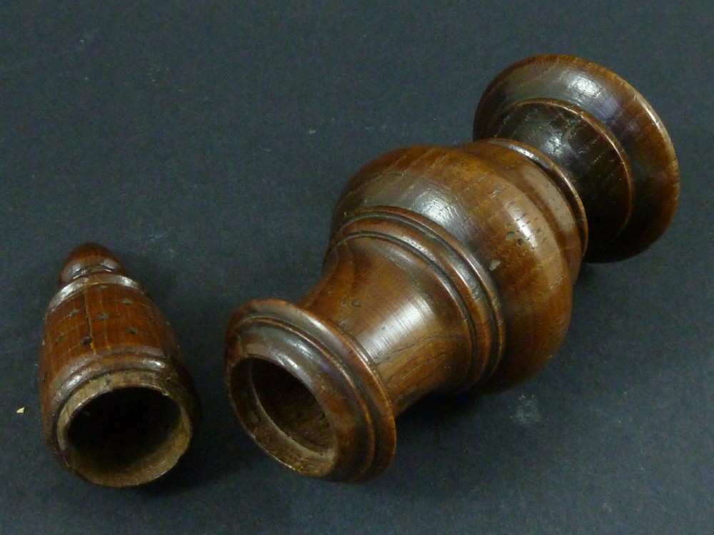 A turned dark wood sugar caster featuring a baluster form, pierced dome top with a finial, and a pedestal base. View IV