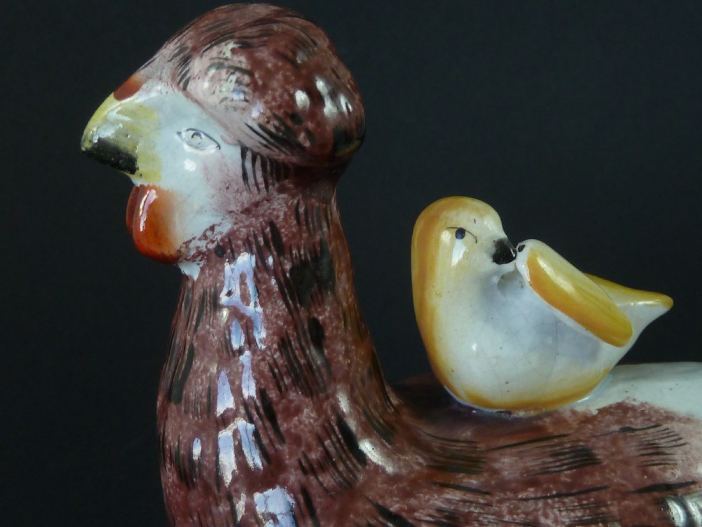 A Victorian glazed earthenware egg tureen shaped like a brown and white hen with small chicks resting along the lid and base. View V