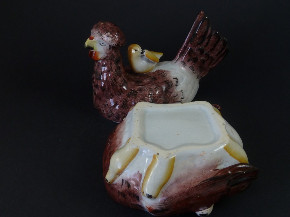 A Victorian glazed earthenware egg tureen shaped like a brown and white hen with small chicks resting along the lid and base. View VIII