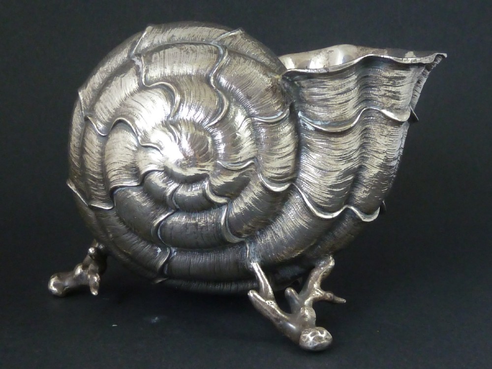A Victorian electroplated nickel silver spoon warmer styled in the form of a nautilus shell supported by a cast coral branch base. View IV