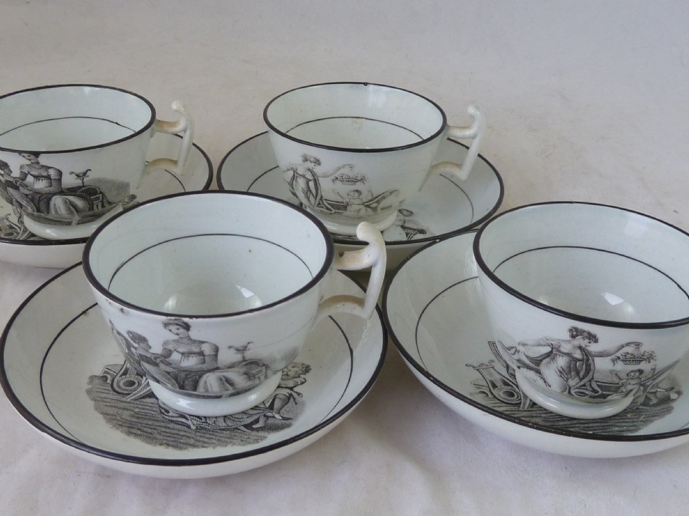 A Georgian era black transfer-printed miniature pearlware tea set featuring a teapot, sugar bowl, milk jug, bowls, cups, and saucers decorated with classical figural scenes. View III