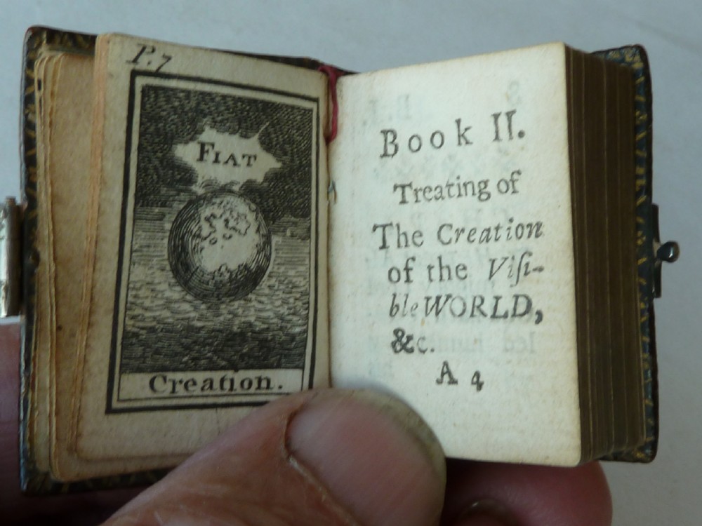 An 18th-century miniature leather-bound thumb bible featuring embossed acorn motifs and a metal clasp closure. View VI