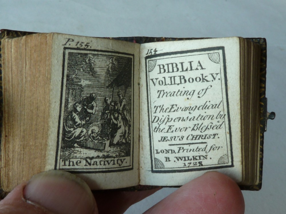 An 18th-century miniature leather-bound thumb bible featuring embossed acorn motifs and a metal clasp closure. View VIII
