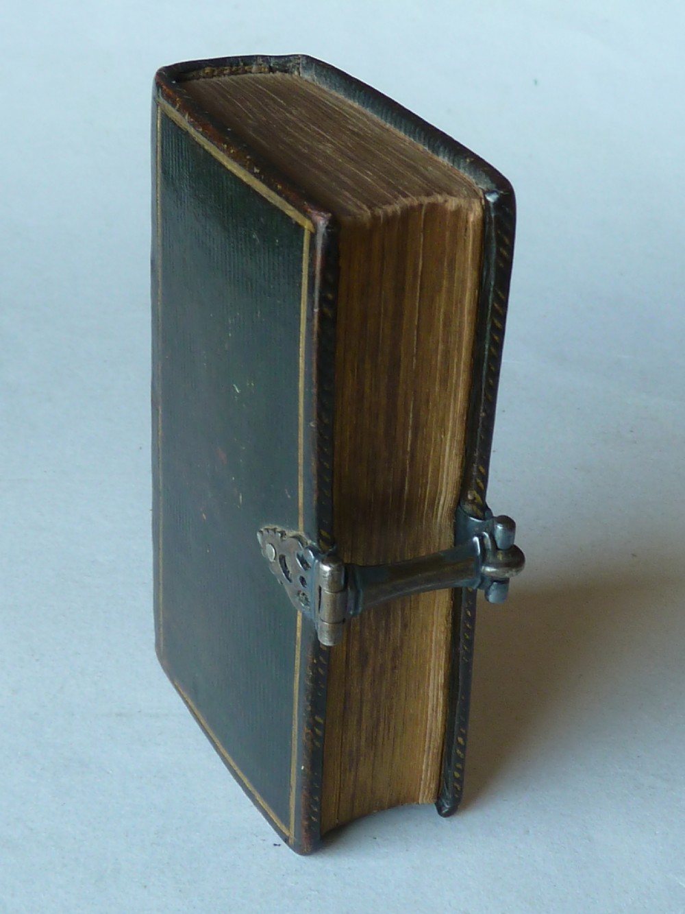An eighteenth-century miniature Dutch leather-bound psalm book with gilt page edges and a silver metal clasp closure. View III