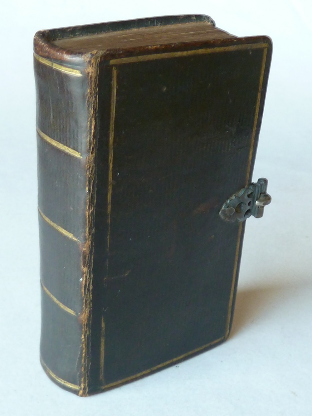 An eighteenth-century miniature Dutch leather-bound psalm book with gilt page edges and a silver metal clasp closure. View IV
