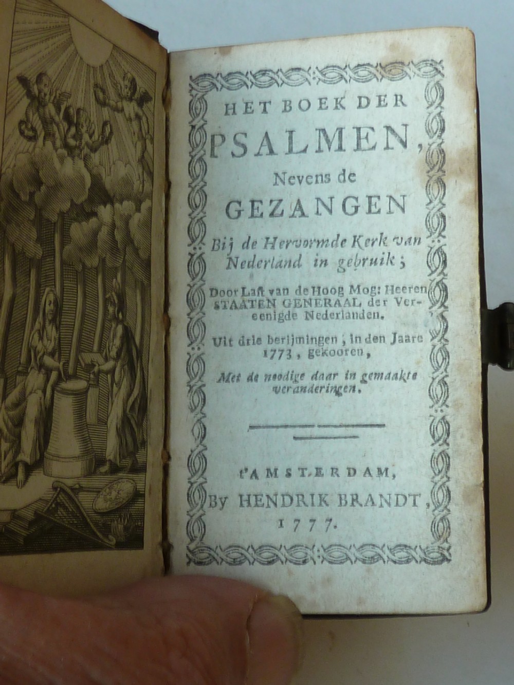 An eighteenth-century miniature Dutch leather-bound psalm book with gilt page edges and a silver metal clasp closure. View V