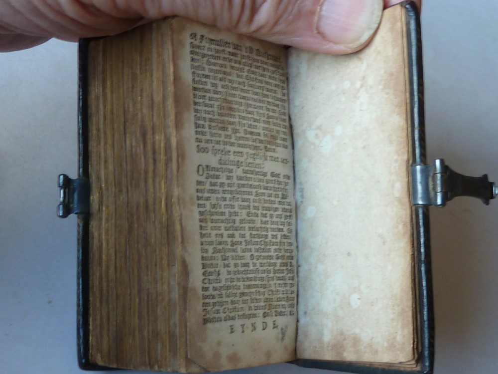 An eighteenth-century miniature Dutch leather-bound psalm book with gilt page edges and a silver metal clasp closure. View VII