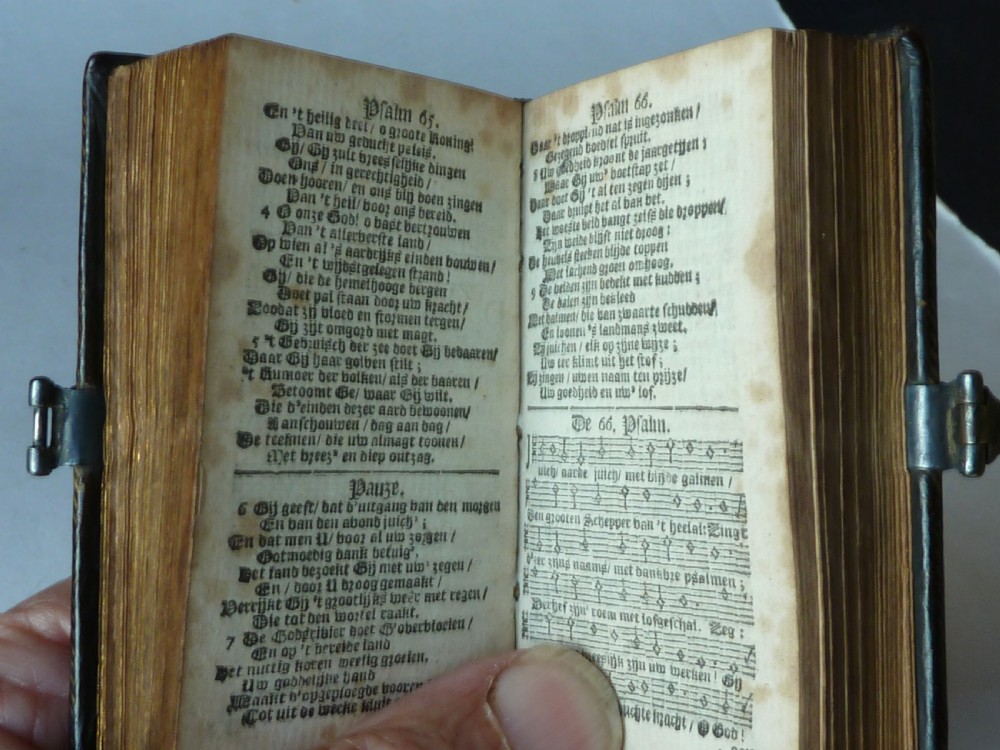 An eighteenth-century miniature Dutch leather-bound psalm book with gilt page edges and a silver metal clasp closure. View IX