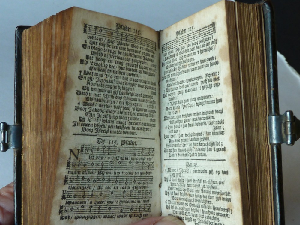 An eighteenth-century miniature Dutch leather-bound psalm book with gilt page edges and a silver metal clasp closure. View X