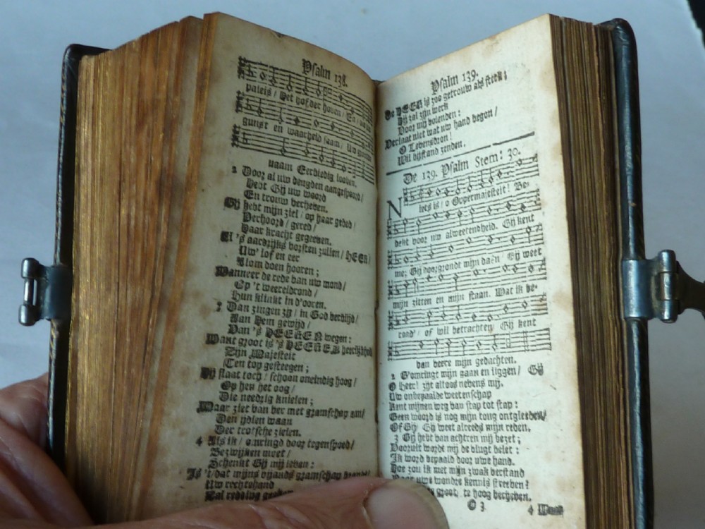 An eighteenth-century miniature Dutch leather-bound psalm book with gilt page edges and a silver metal clasp closure. View XI