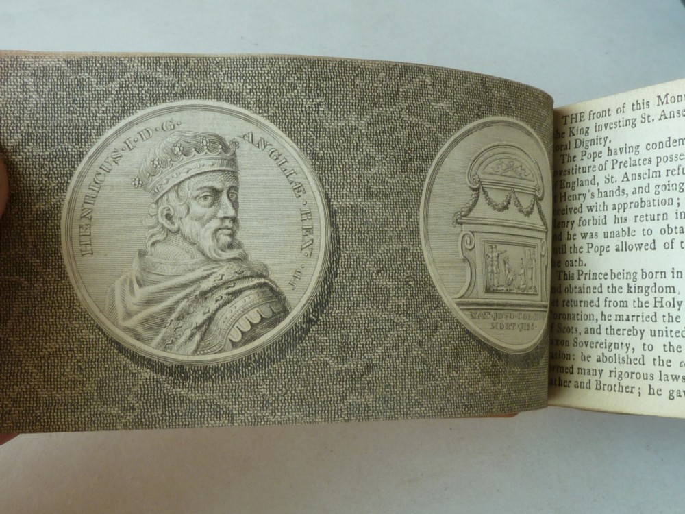A small antique leatherbound book with a brown calfskin cover featuring gilt border tooling and aged paper edges. View VII