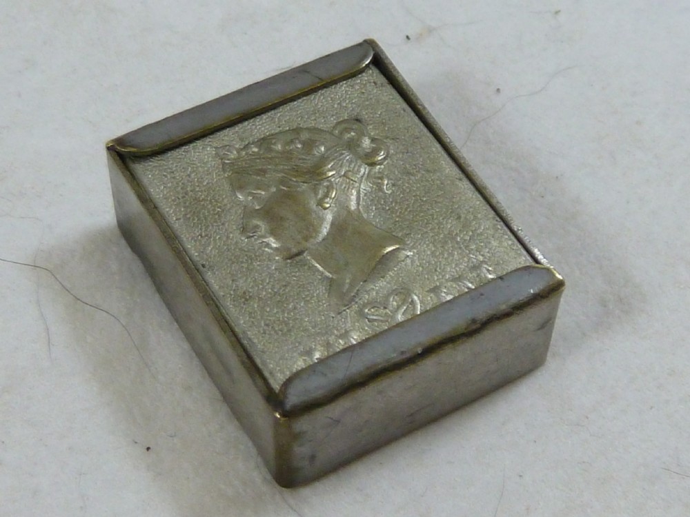 A small rectangular silver-plated stamp box featuring an embossed relief portrait of Queen Victoria in profile on the lid.