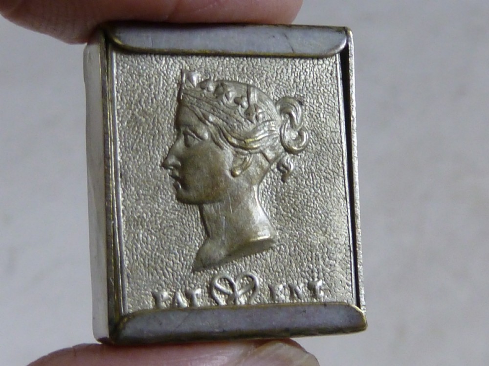 A small rectangular silver-plated stamp box featuring an embossed relief portrait of Queen Victoria in profile on the lid. View IV