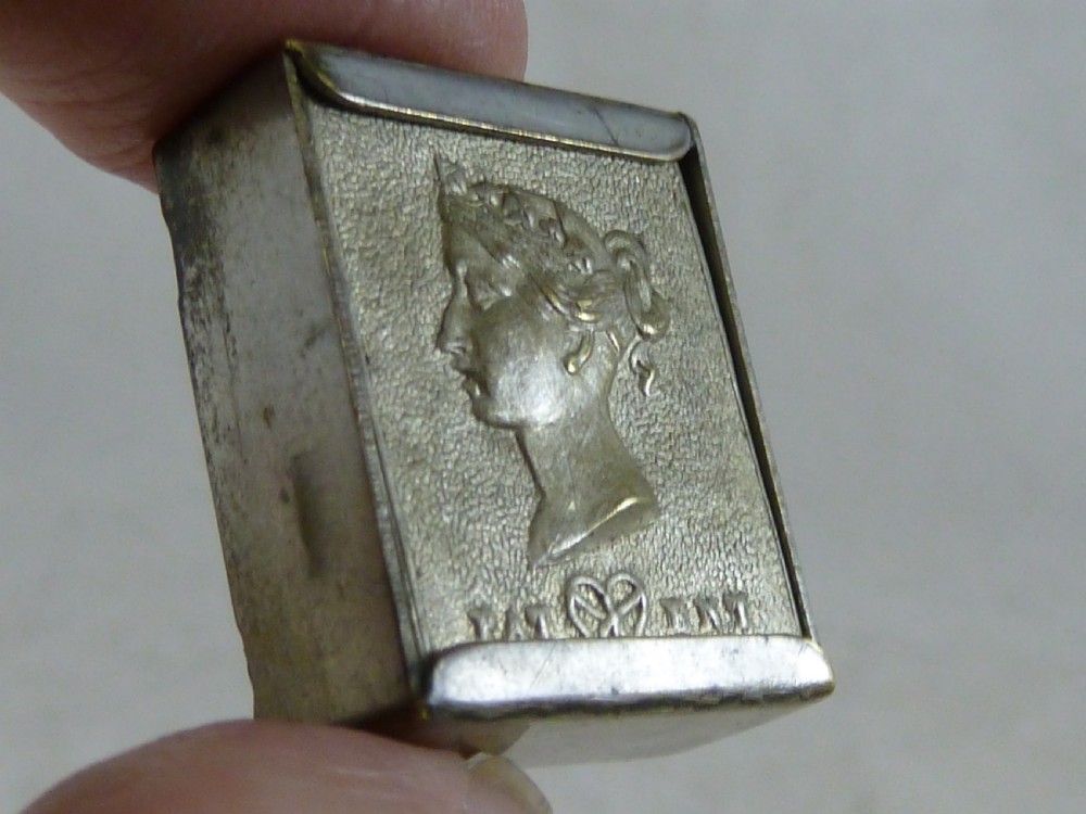 A small rectangular silver-plated stamp box featuring an embossed relief portrait of Queen Victoria in profile on the lid. View VI