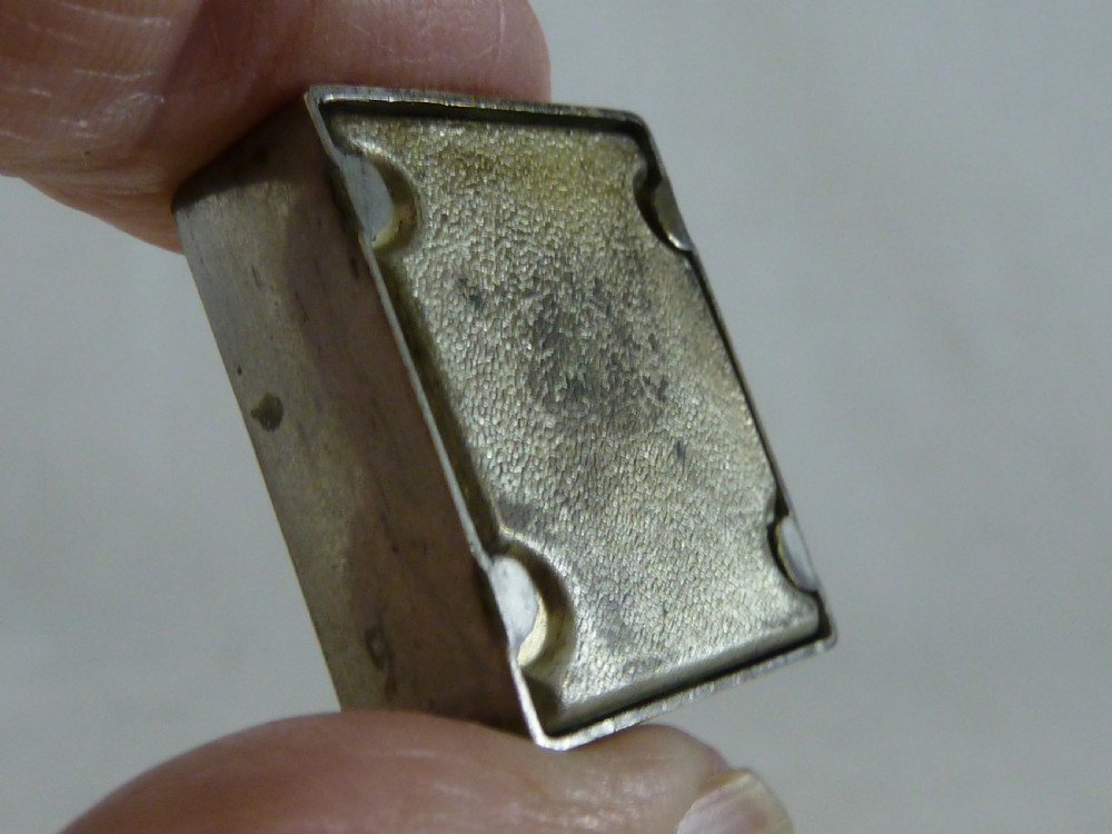 A small rectangular silver-plated stamp box featuring an embossed relief portrait of Queen Victoria in profile on the lid. View VII