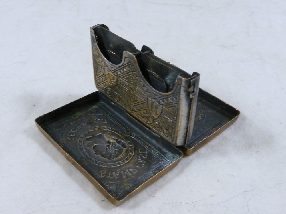 A small rectangular Victorian brass pocket stamp case embossed with a portrait of Queen Victoria and registration text dated 1874. View III
