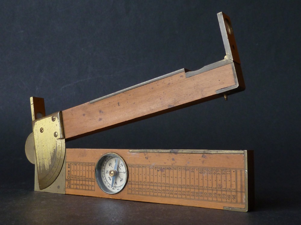 An antique boxwood and brass folding clinometer rule featuring an integrated magnetic compass, spirit level, folding sight vanes, and engraved measurement scales. View III
