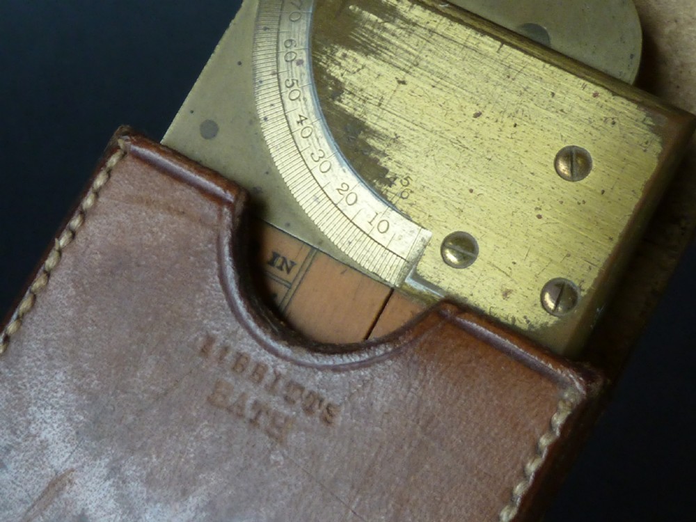 An antique boxwood and brass folding clinometer rule featuring an integrated magnetic compass, spirit level, folding sight vanes, and engraved measurement scales. View IV