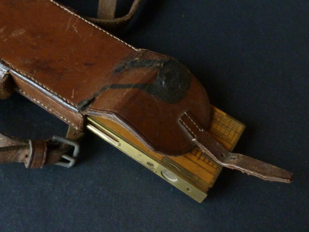 An antique boxwood and brass folding clinometer rule featuring an integrated magnetic compass, spirit level, folding sight vanes, and engraved measurement scales. View VI