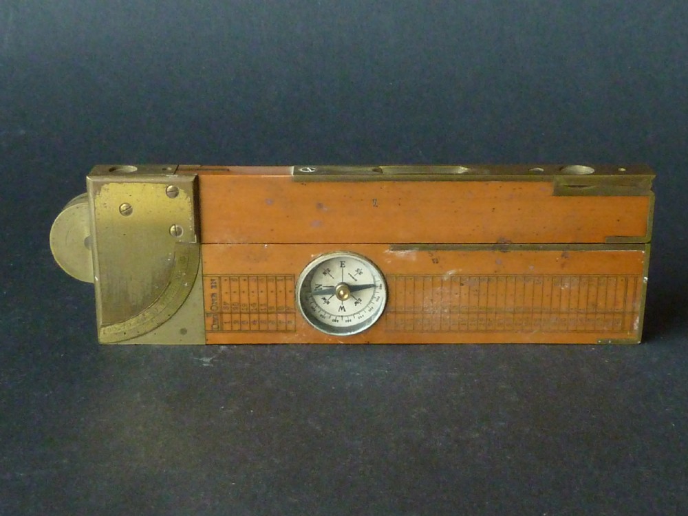An antique boxwood and brass folding clinometer rule featuring an integrated magnetic compass, spirit level, folding sight vanes, and engraved measurement scales. View VII